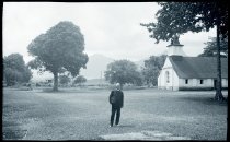 Father Joseph (Hubert) Verschueuren, SS.CC., with Saint Ann Church in the distance, Heeia, Oahu.